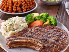 In Tim’s Big Book of Restaurant Reviews, the Outback Steakhouse of Clearwater, Florida, Has Earned an Overall Rating of 9.9 Out of 10 A plate of food on a table
